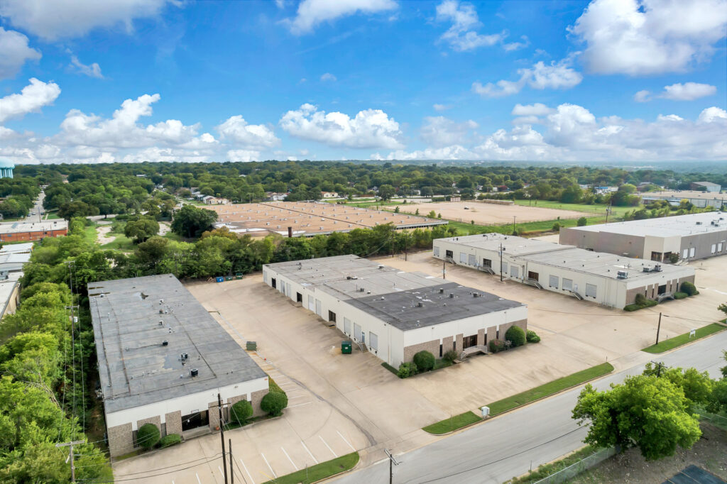 Aerial view of the Suffolk Business Park with three white buildings situated parallel to each other with parking in between