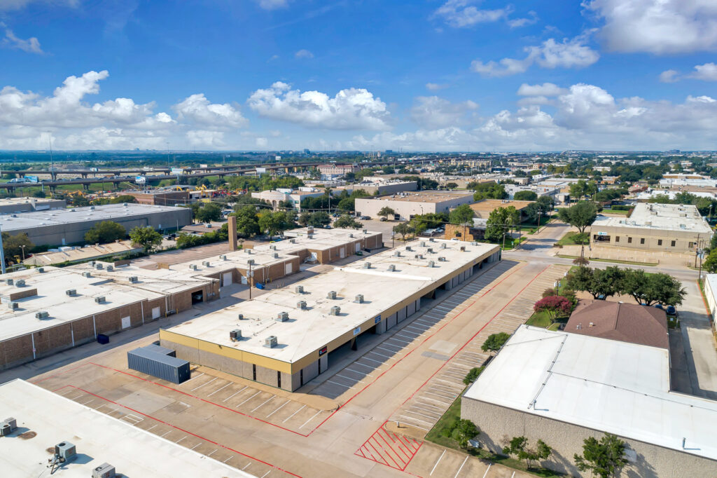 Aerial view of a grey building with yellow siding adjacent to a brown building inside of the Manana Business Park