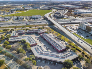 Aerial view of the Fossil Creek Tech Center consisting of five, red buildings in a circular shape with grey roofs