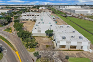 Overhead view of 700 Industrial Boulevard showcasing the roof, parking lot, and entire length of the building